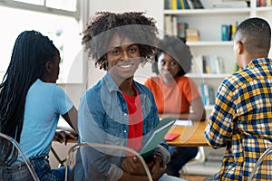 African american male college student at desk at classroom