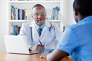 African american male doctor listening to infected patient