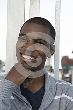 African American male model smiling hand on his chin