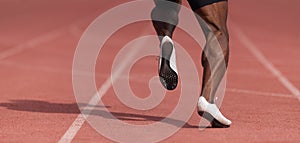 African-american male sportsman running on stadium track