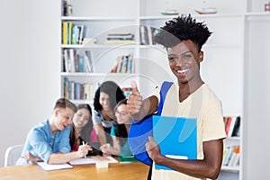 African american male student with eyeglasses and group of international students