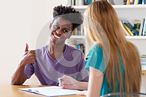 African american male student preparing for exam on private lesson