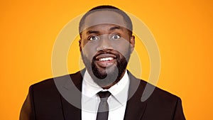 African-american male in suit smiling and looking to camera, successful manager