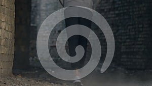 African american male teen strolling in abandoned building, loneliness concept