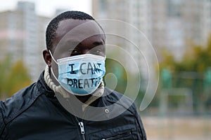 African american man activist in mask with an inscription I CANT BREATHE