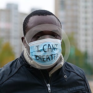 African american man activist in mask with an inscription I CANT BREATHE