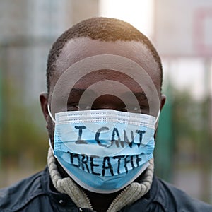 African american man activist in mask with an inscription I CANT BREATHE