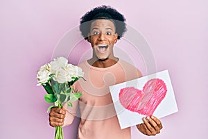 African american man with afro hair bouquet of flowers and heart draw for anniversary celebrating crazy and amazed for success