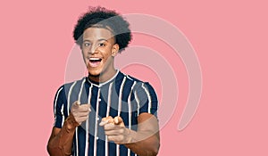 African american man with afro hair wearing casual clothes pointing fingers to camera with happy and funny face