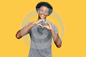 African american man with afro hair wearing casual clothes smiling in love doing heart symbol shape with hands