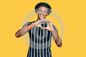 African american man with afro hair wearing casual clothes smiling in love doing heart symbol shape with hands