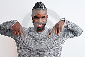 African american man with braids wearing grey sweater over isolated white background looking confident with smile on face,