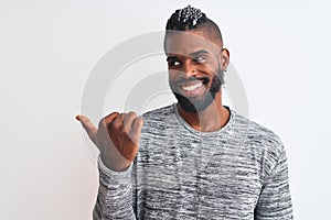 African american man with braids wearing grey sweater over isolated white background smiling with happy face looking and pointing