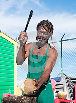 African american man breaking coconut