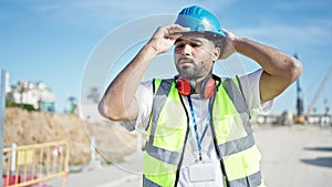 African american man builder smiling confident wearing hardhat at street