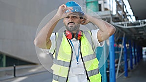 African american man builder smiling confident wearing hardhat at street