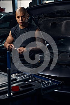 African American man changing sockets on socket wrench