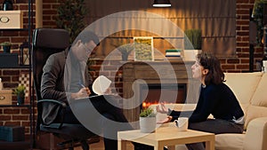 African american man consulting woman laying on couch