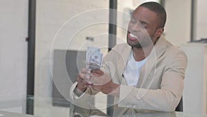 African American Man Counting Money, Enjoying Profit