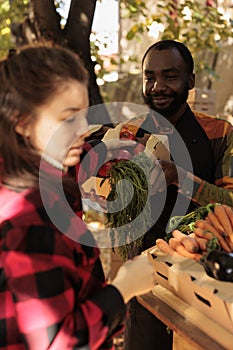 African american man displaying bio fruits or vegetables