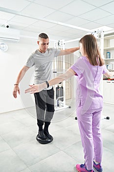 African American man doing physiotherapy exercise in clinic