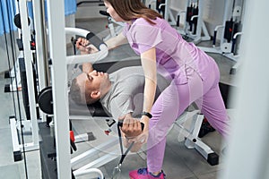 African American man doing rehabilitation exercise with physiotherapist