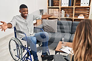 African american man doing therapy sitting on wheelchair looking at the camera smiling with open arms for hug