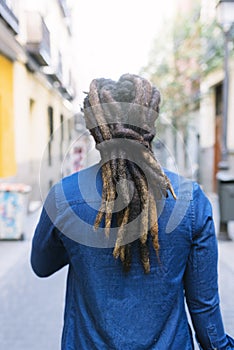 African american man with dreadblocks in the street.