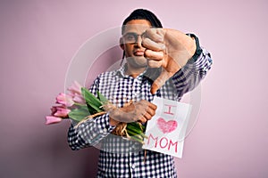 African american man with dreadlocks holding love mom message and tulips on mothers day with angry face, negative sign showing