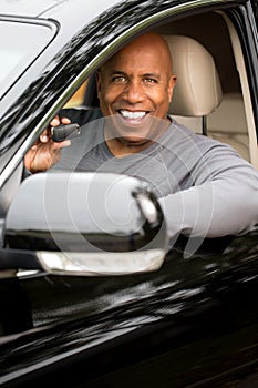 African American man driving a new car