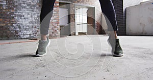 African american man exercising with medicine ball in an empty urban building