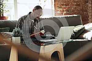 African-american man, freelancer during the work in home office while quarantine