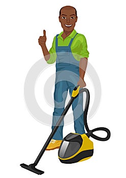 African american man in green coveralls posing with vacuum cleaner and giving thumbs up