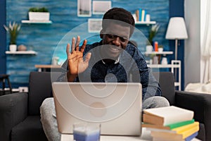 African american man greeting remote collegue during online videocall photo