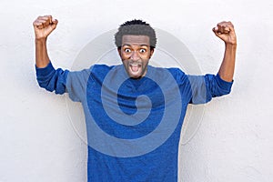 African american man with hands raised in shock and disbelief