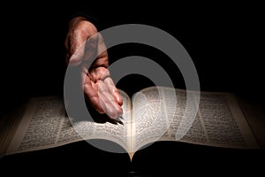 African American Man Hands Showing to the Bible, the Word of God