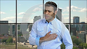 African-american man having chest pain.