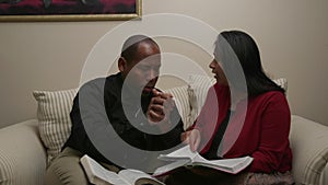 African American Man and Hispanic Woman Read the Bible and Pray