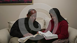 African American Man and Hispanic Woman Read and Discuss Bible