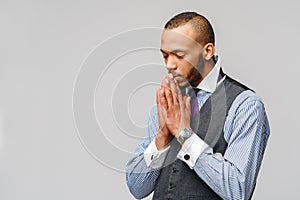 African american man holding hands in prayer hoping for better