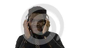 African american man holding headphones with both hands and groo