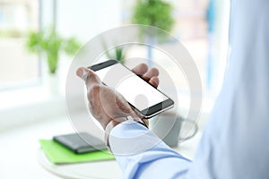 African-American man holding mobile phone