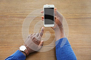 African-American man holding mobile phone