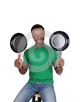 African American man holding up two freeing pan