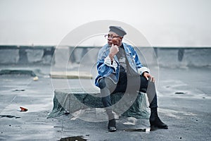 African american man in jeans jacket, beret and eyeglasses