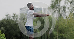 African american man limbering-up and stretching legs after running jog workout. Runner stretching and warming-up before