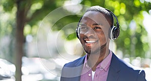 African American Man Listening Music On Wireless Headphones