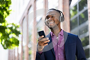 African American Man Listening Music On Wireless Headphones