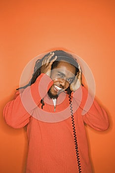 African-American man listening to headphones.