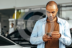 African american man lookin at his smartphone